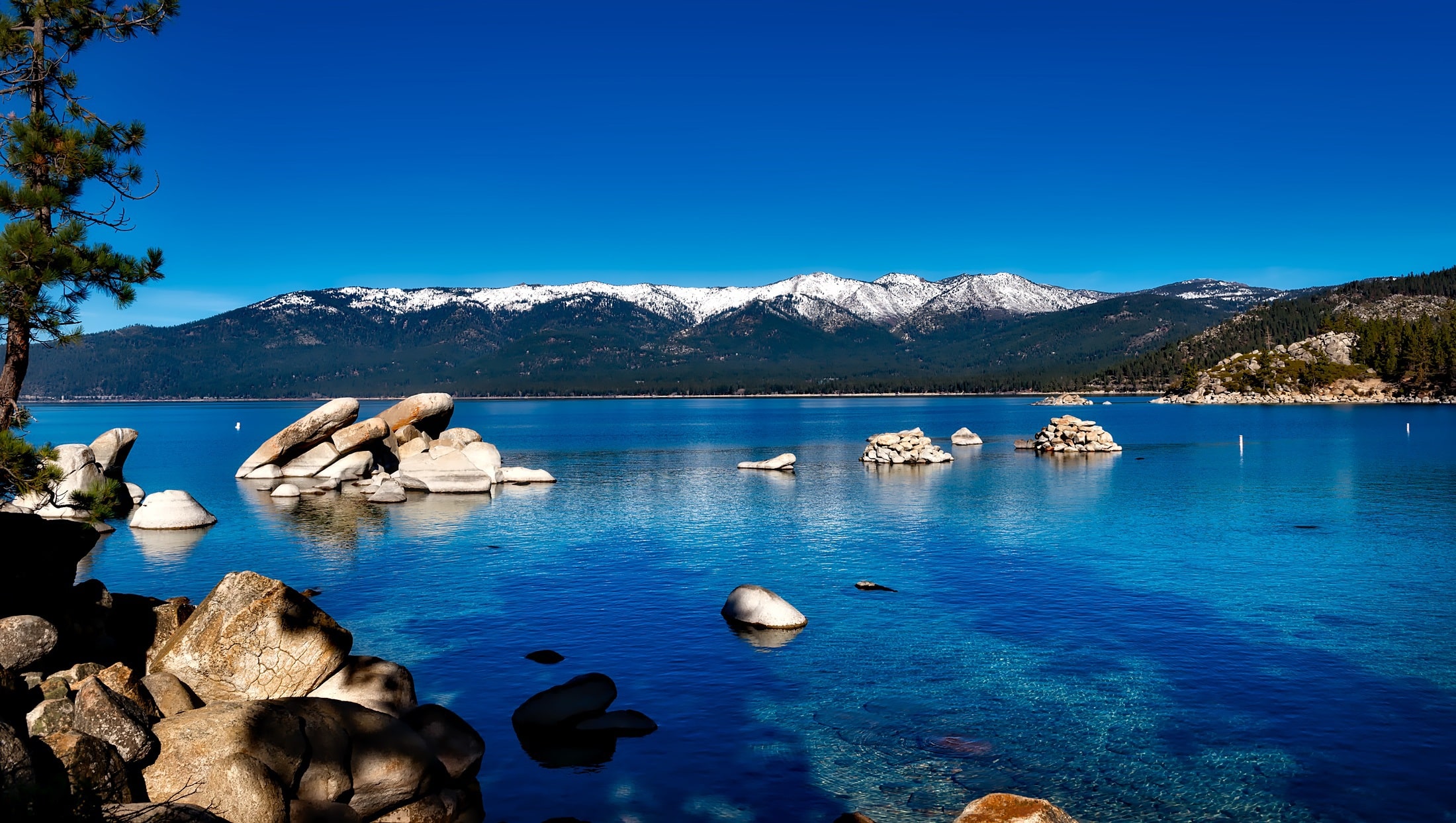 Beautiful scenery of Lake Tahoe with a snowy mountain in the background
