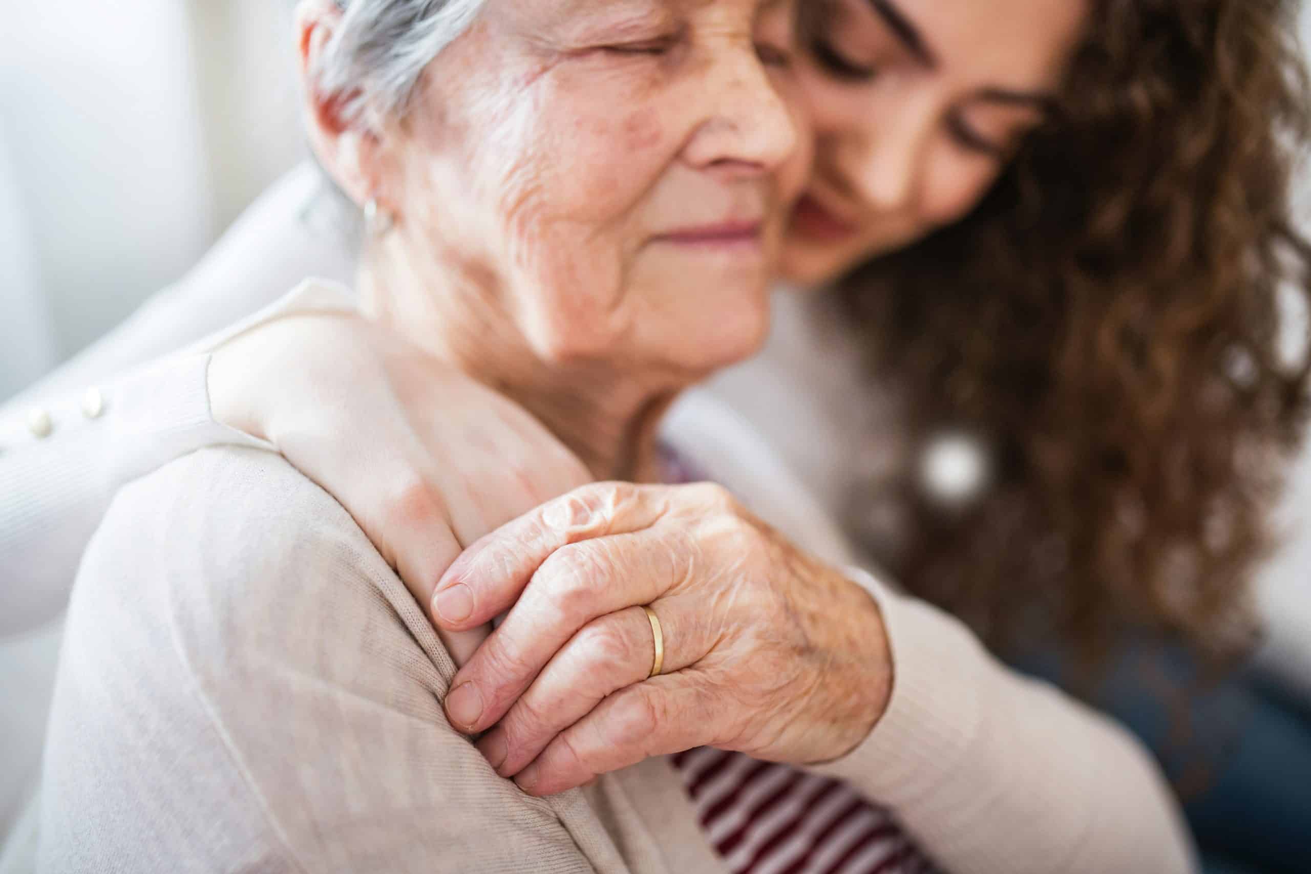 Companion caregiver offering emotional support and comfort to an older adult through gentle, in home companionship