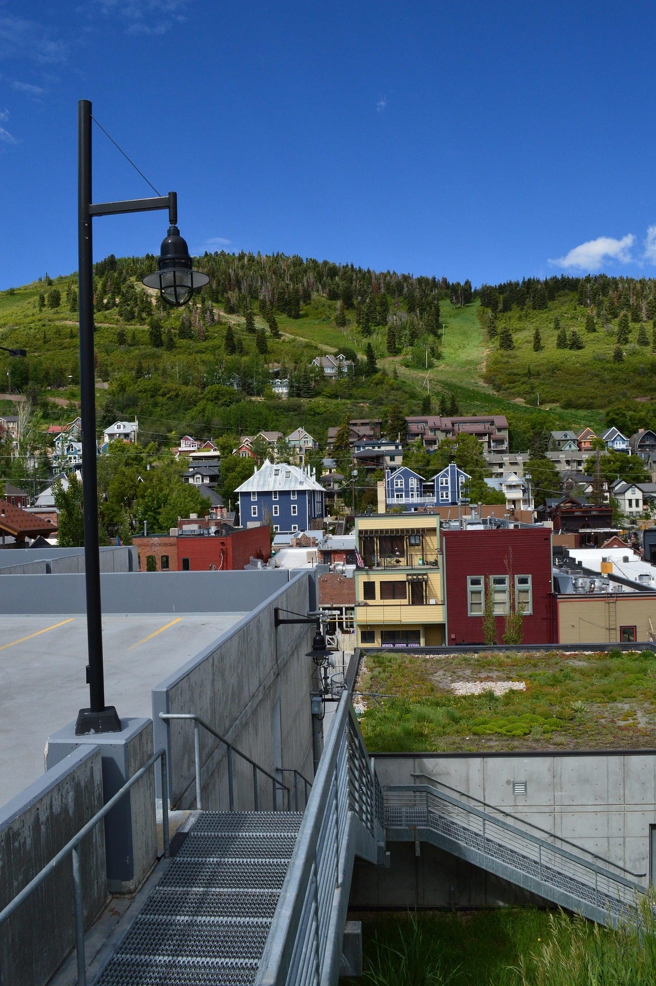 Hillside residential neighborhood in Utah with homes, greenery, and mountain terrain