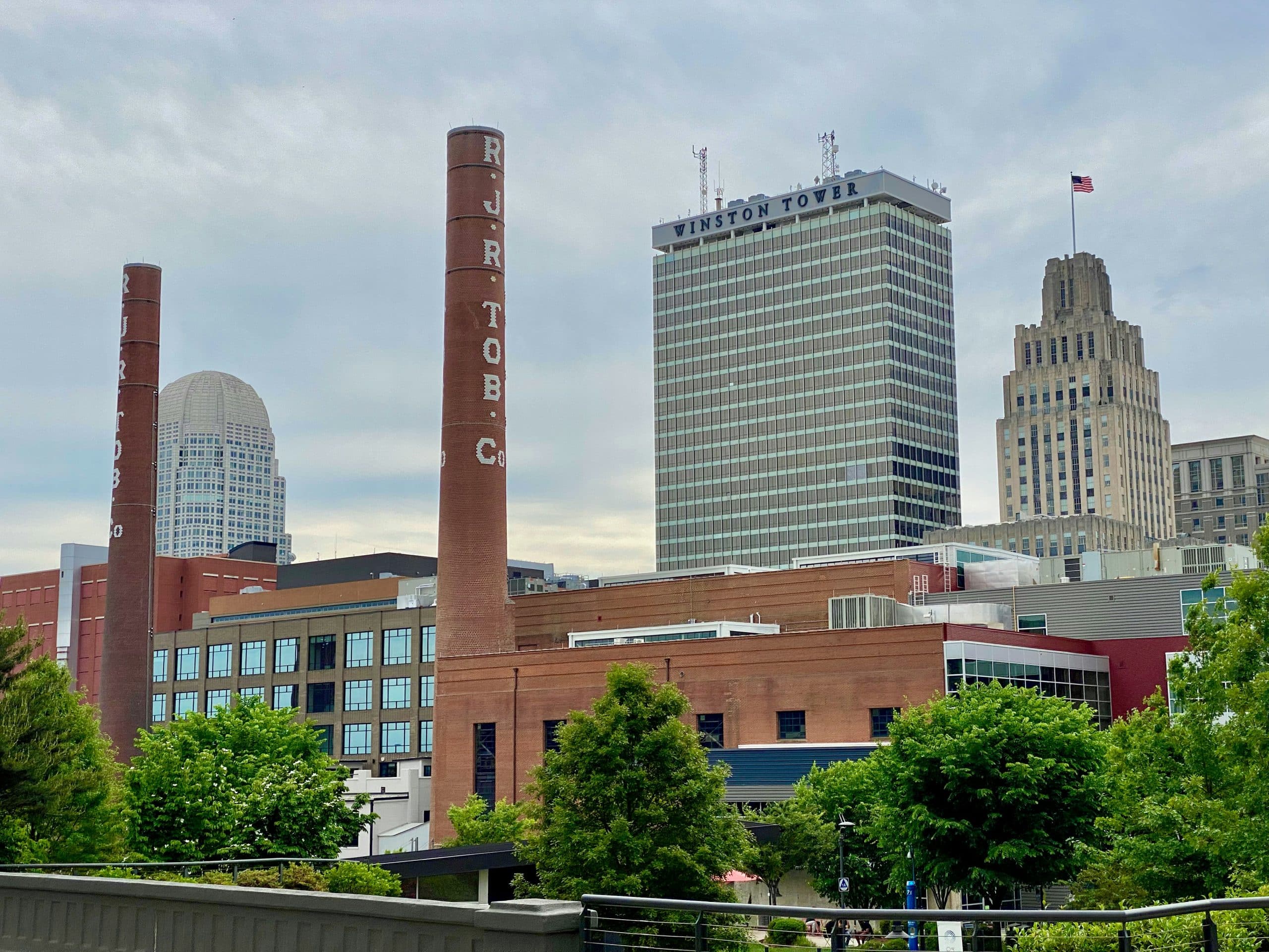 Downtown Winston Salem North Carolina skyline with historic RJ Reynolds Tobacco Company smokestacks and Winston Tower